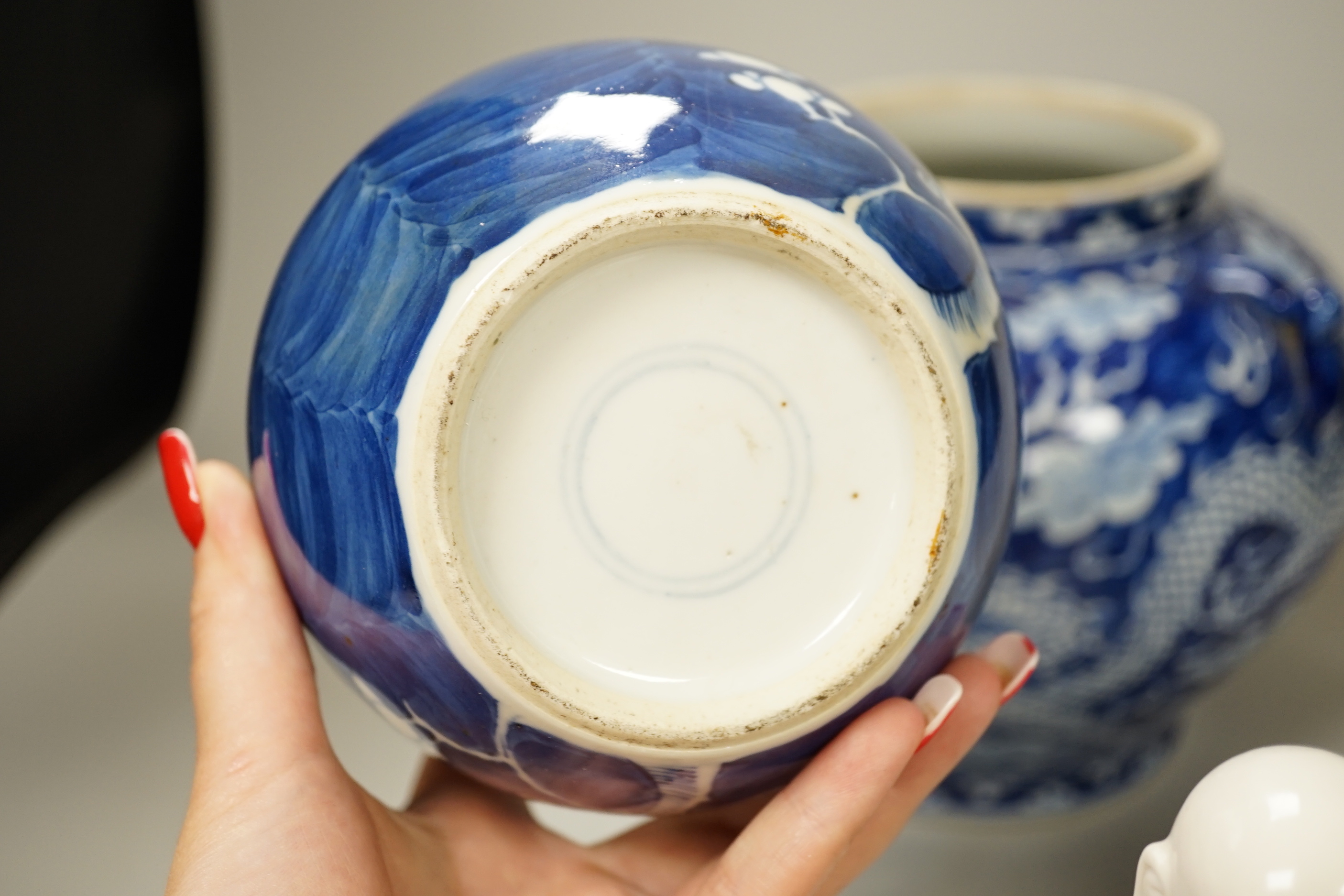 A group of Chinese ceramics including a celadon glazed vase, blue and white jar, white glazed figure and a jardiniere